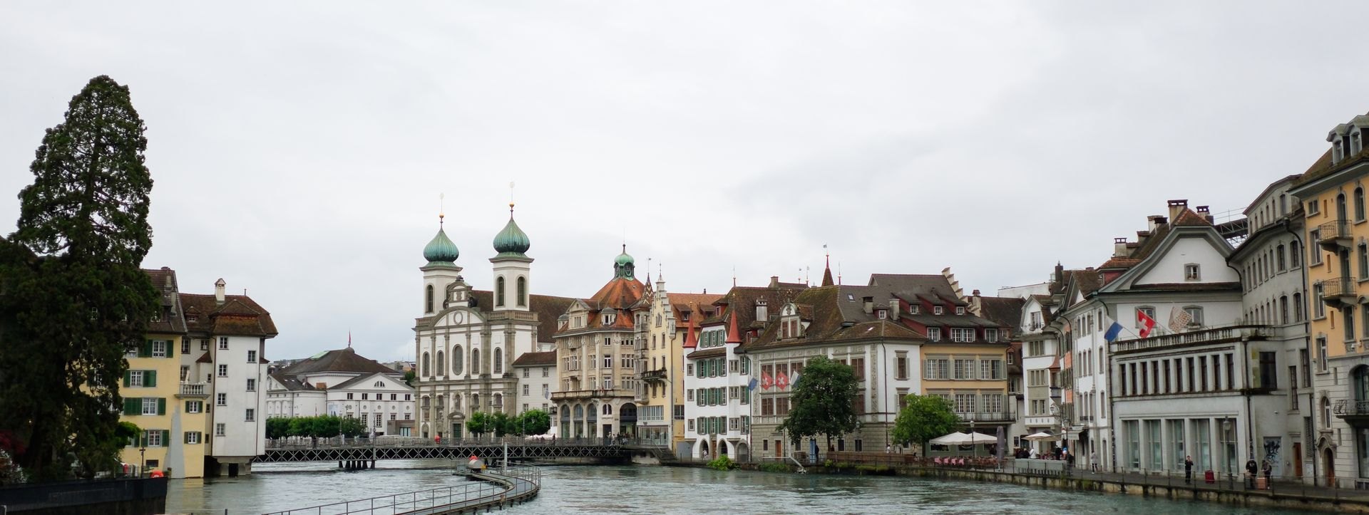 Historic buildings along a river in Lucerne; illustrative city photograph